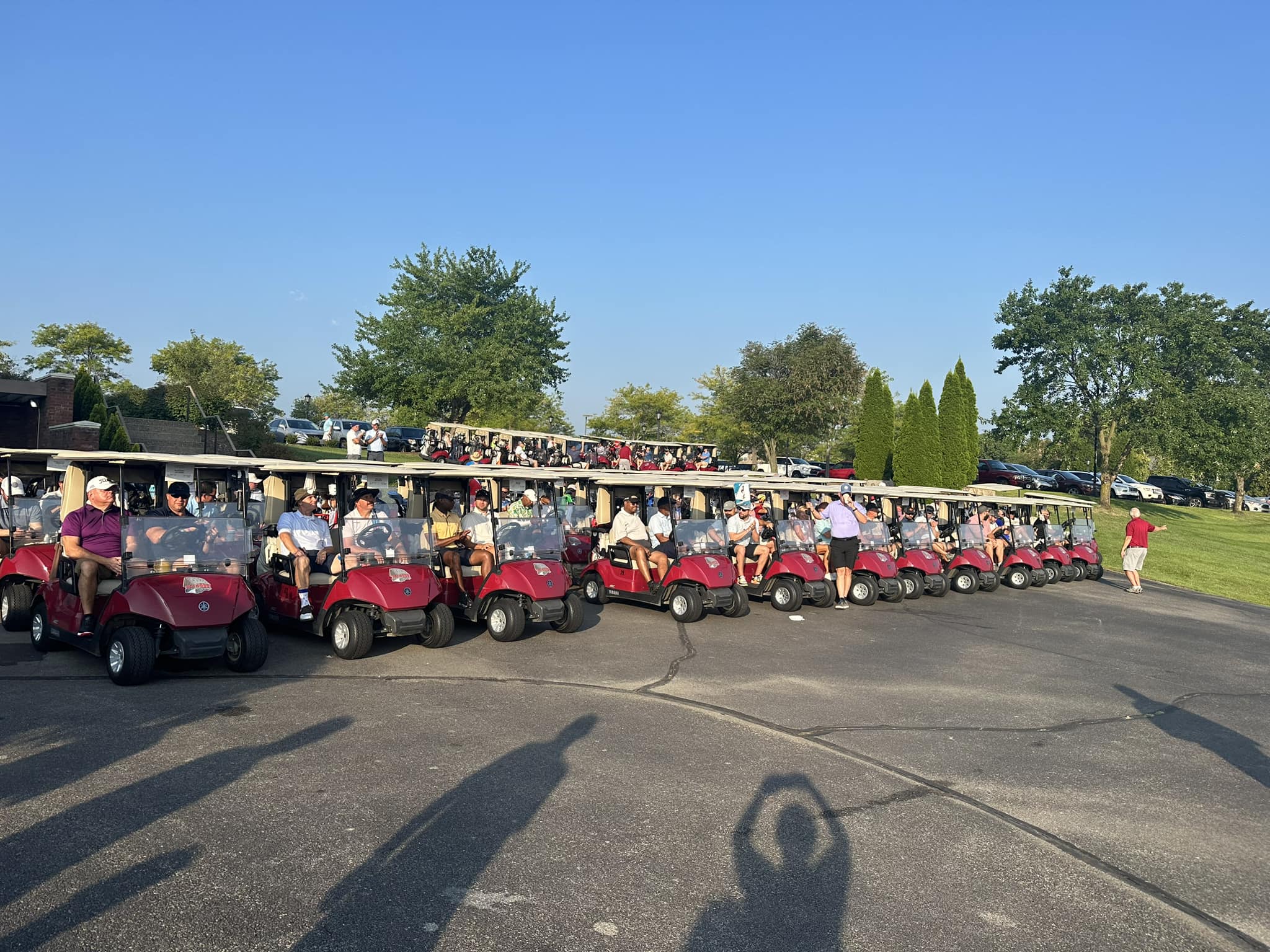 Rows of golf carts lined up ready to go out on the course.